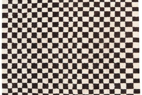Detail close-up showcasing the black and white checkered design of the rug.