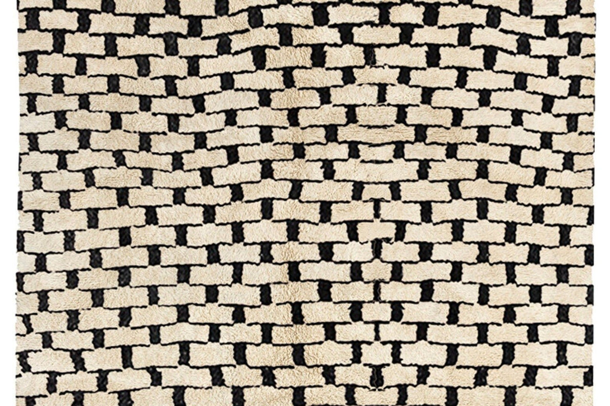 Close-up detail of the woven pattern and texture of the gray checkered Beni Ourain Moroccan rug.