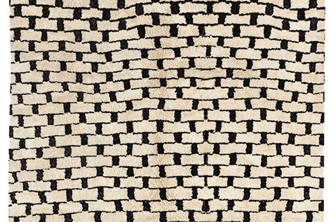 Close-up detail of the woven pattern and texture of the gray checkered Beni Ourain Moroccan rug.