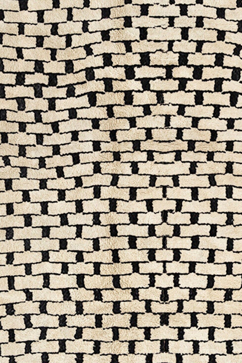 Close-up detail of the soft texture and woven pattern of the gray checkered Beni Ourain Moroccan rug.