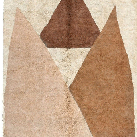 Close-up detail of the abstract Moroccan rug highlighting its geometric design in beige and brown.