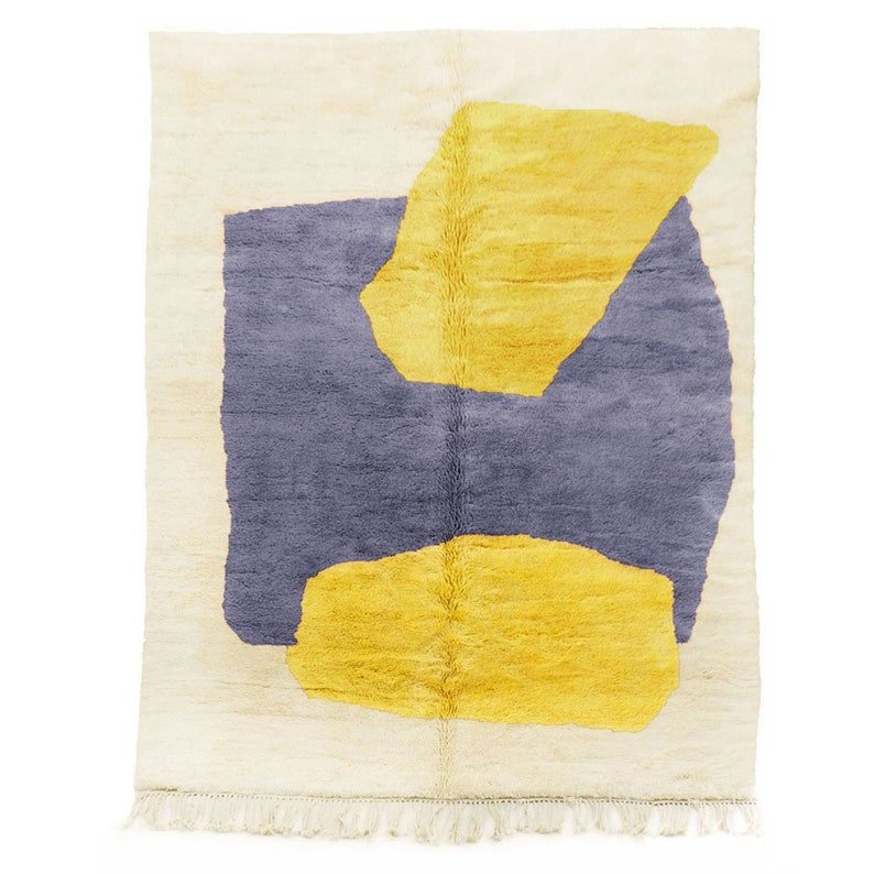 Detail shot of the mustard abstract Moroccan rug showcasing geometric patterns in yellow and purple.