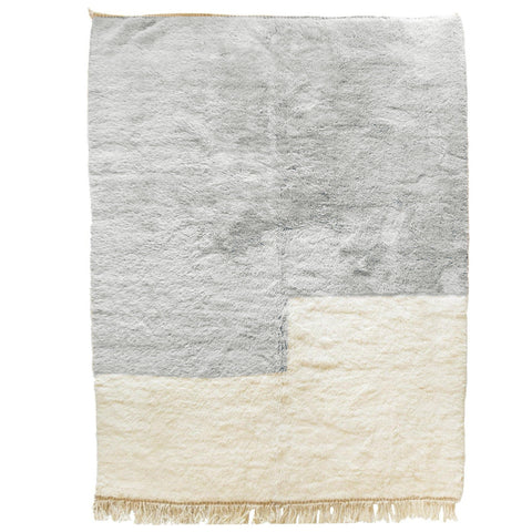 Front view of the gray and white Moroccan rug highlighting its textured surface and fringe edges.