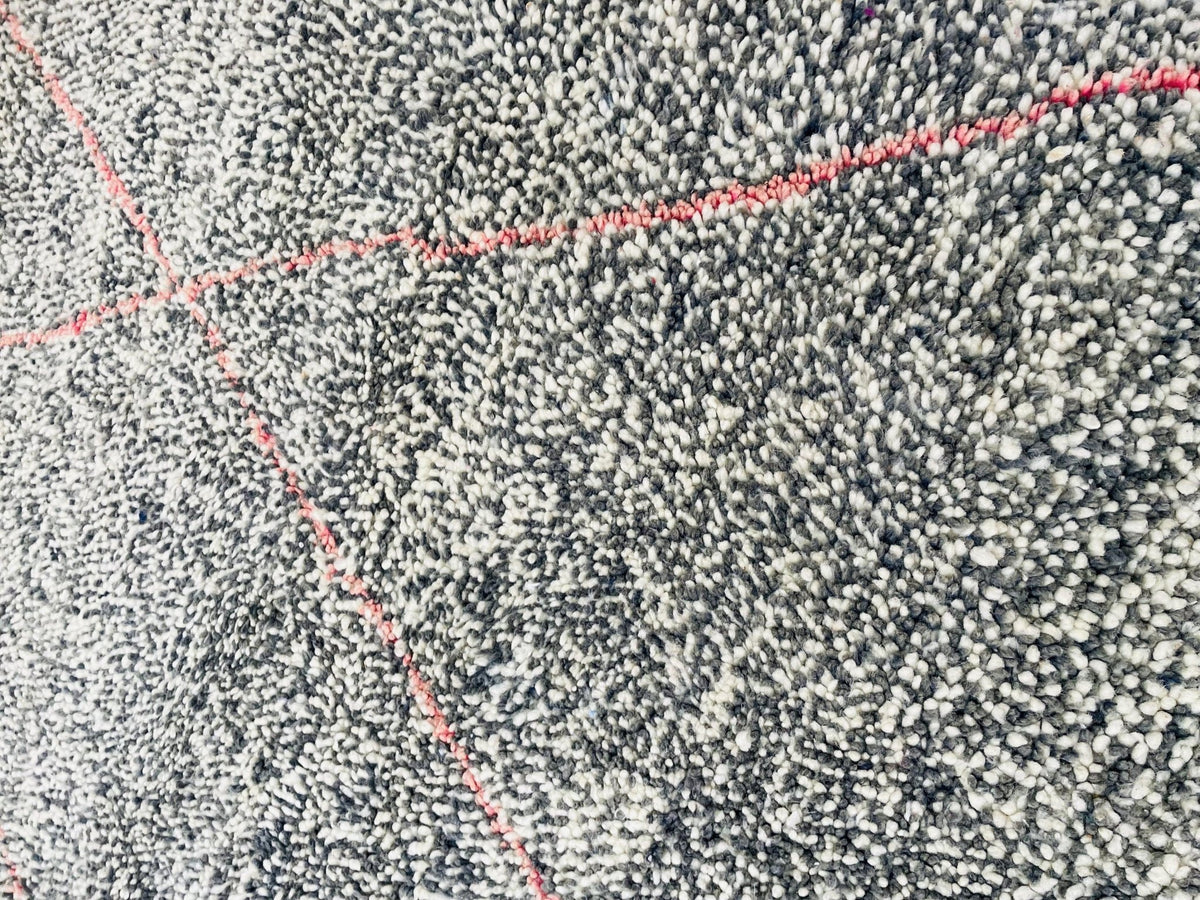 Detailed view of the textured surface of a gray geometric Beni Ourain Moroccan rug with a geometric pattern.
