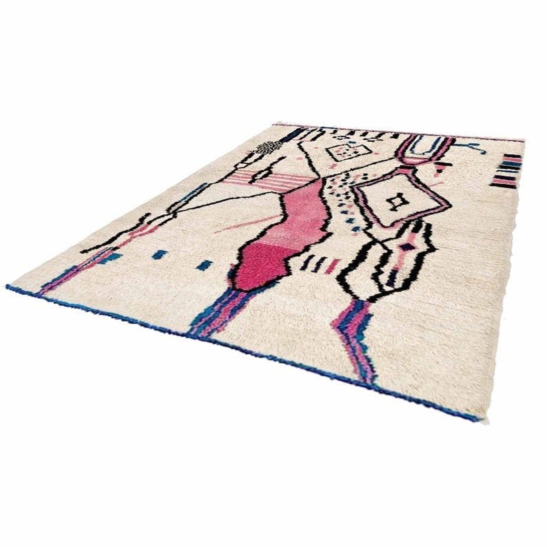Front view of a multicolor tribal pattern Moroccan rug featuring geometric designs in cream, pink, and black.