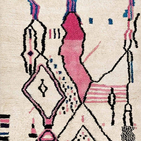 Front view of a multicolor tribal pattern Moroccan rug with geometric patterns in cream, pink, and black.