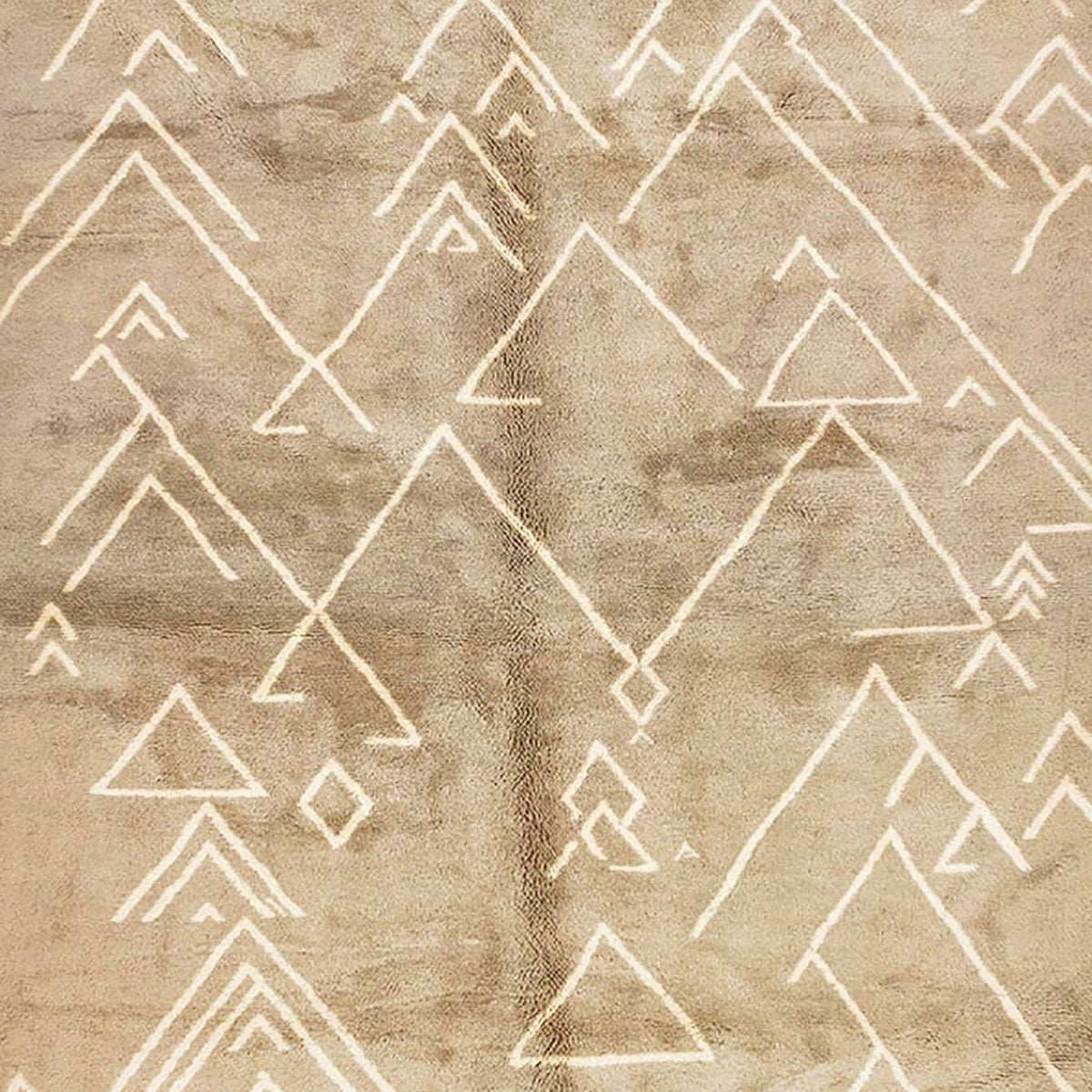 Close-up detail of the geometric pattern on the beige textured Moroccan rug.