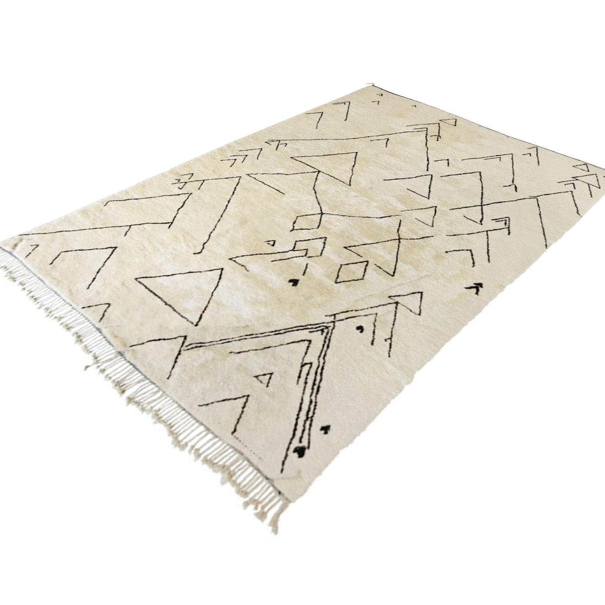 Detail close-up of the off-white Moroccan rug featuring geometric patterns and fringed edges.