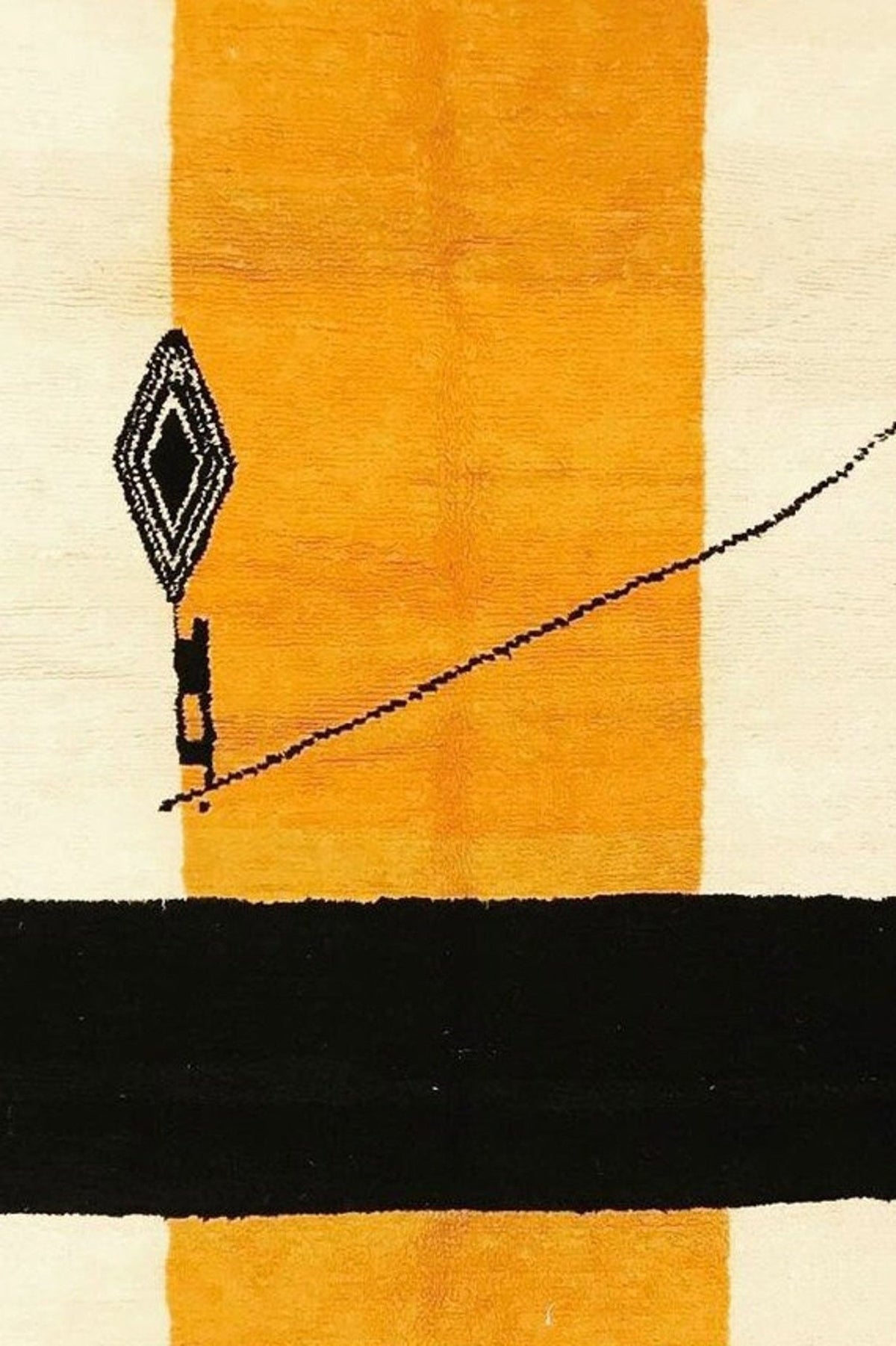 Close-up view of the orange and black geometric pattern on the color block rug.