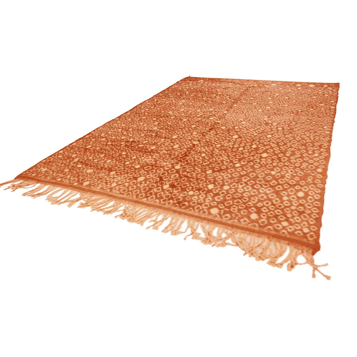 Side view of the orange Moroccan rug highlighting its fringe edges and soft texture.