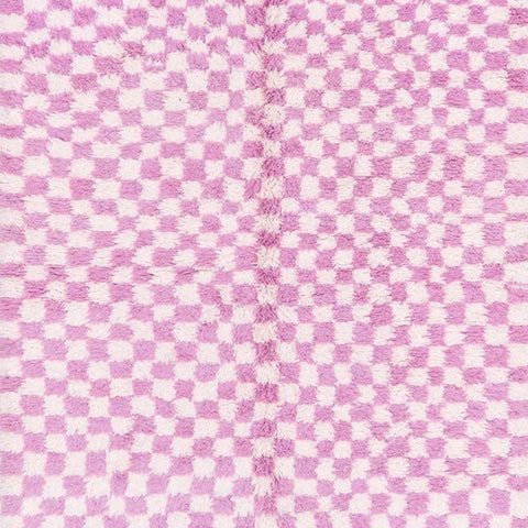 Side view of the pink checkered Beni Ourain Moroccan rug showcasing its abstract design.