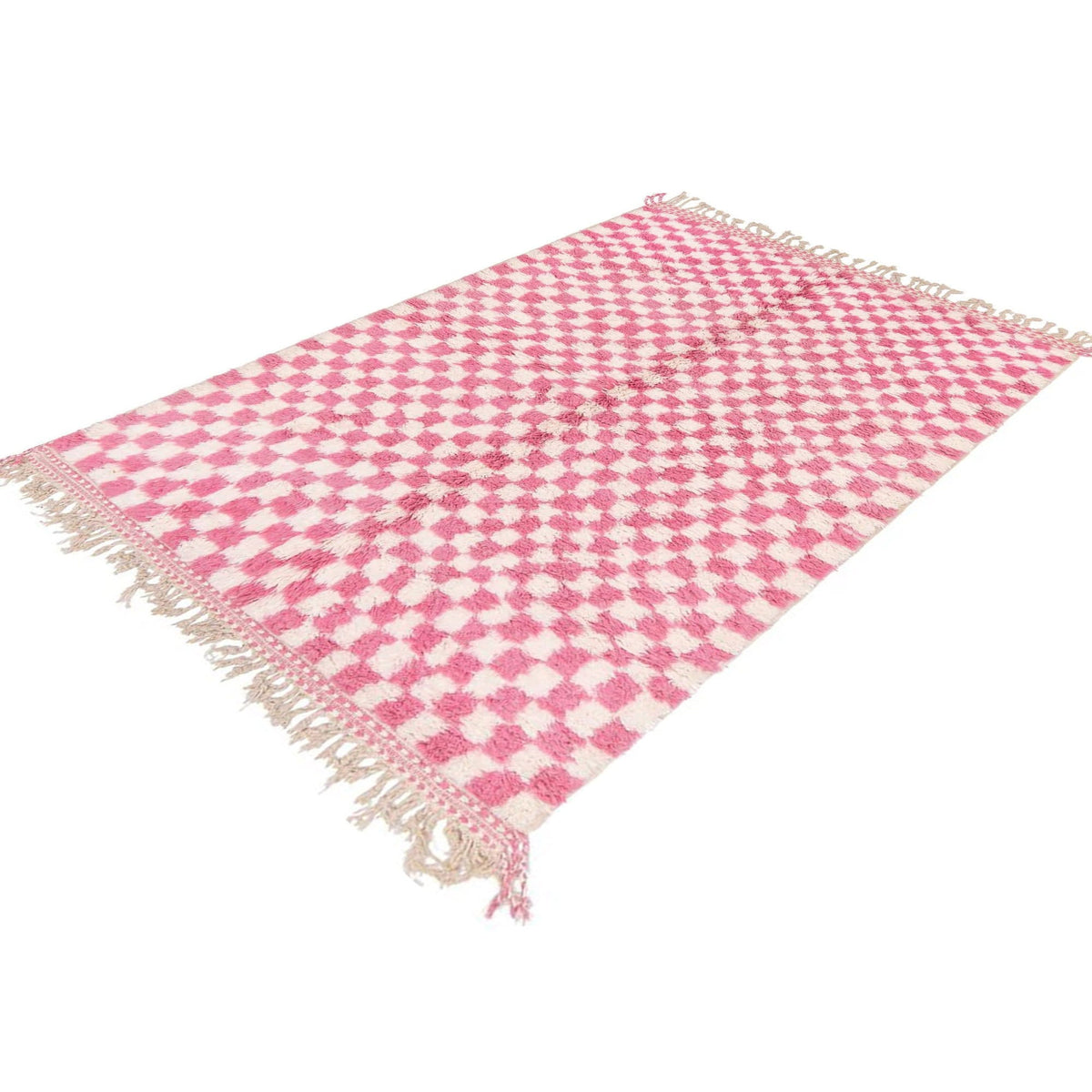 Detail close-up of the pink checkered Beni Ourain rug emphasizing fringe edges.