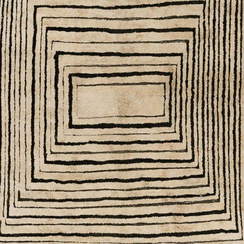 Detail close-up of the taupe and black spiral design on a rectangular Moroccan rug.