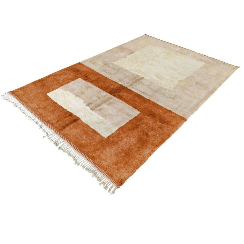 Side view of the taupe and rust orange color block Moroccan rug highlighting its Berber design.