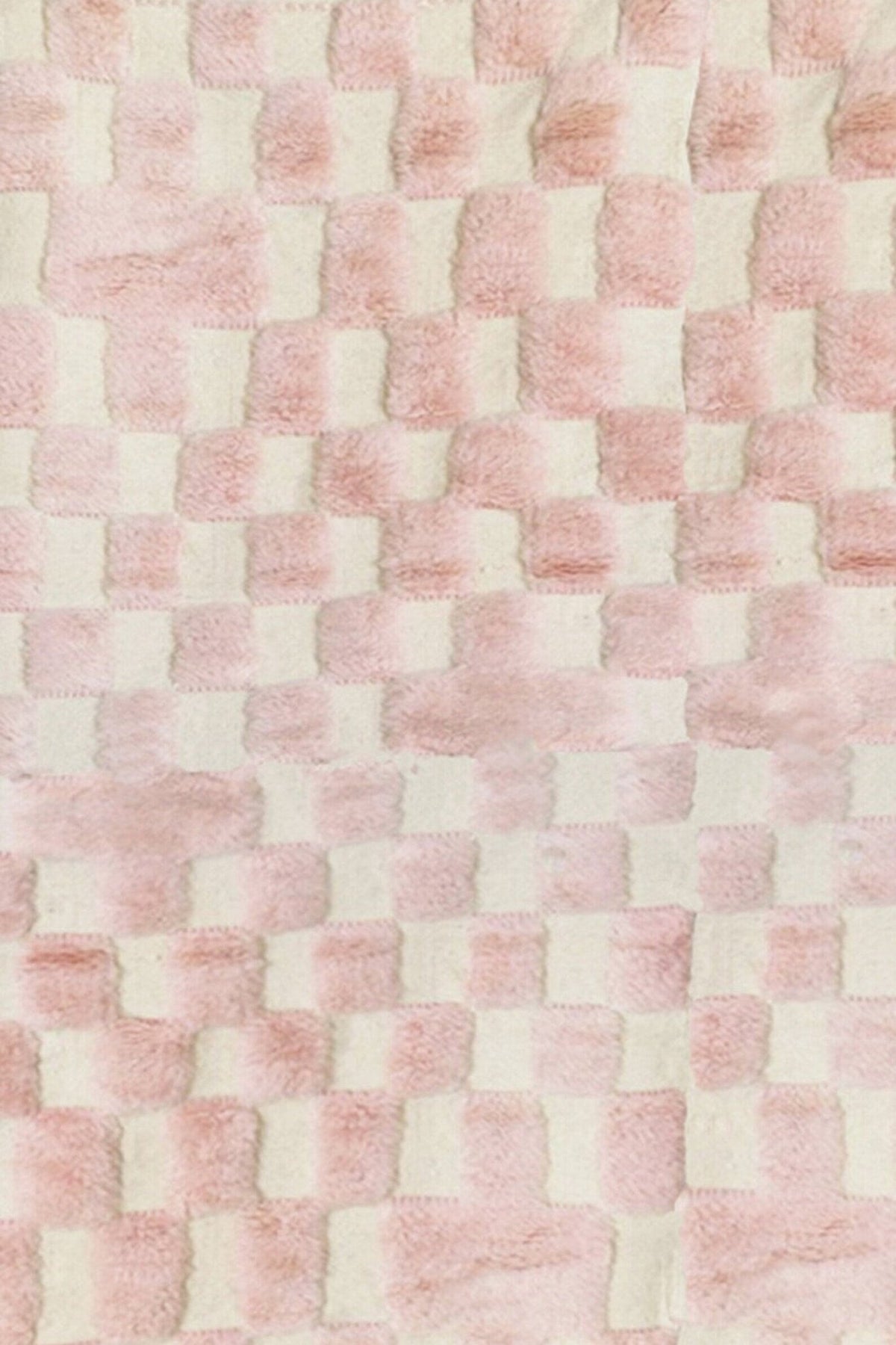 Close-up detail of the pink Beni Ourain rug highlighting its textured design.