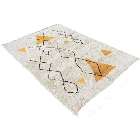 Other angle displaying the yellow and black geometric pattern of the Moroccan rug.