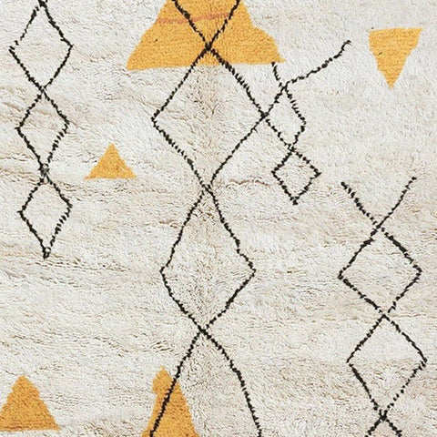 Side angle highlighting the geometric features of the yellow and black Moroccan rug.