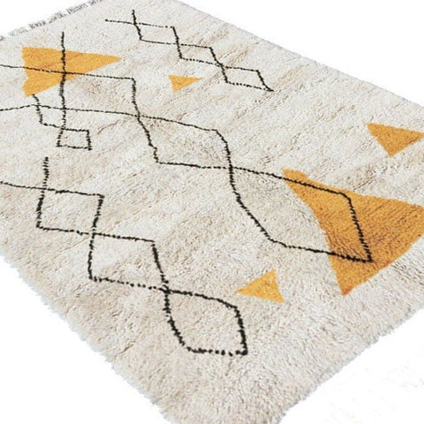 Close-up of the yellow and black geometric design on the Moroccan rug.