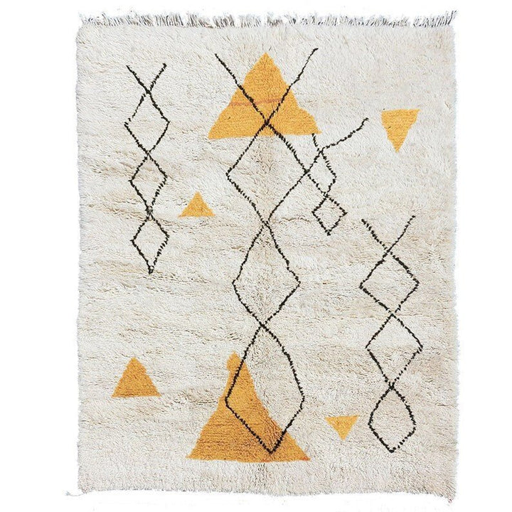 Detail view of the yellow and black geometric pattern on the Moroccan rug.