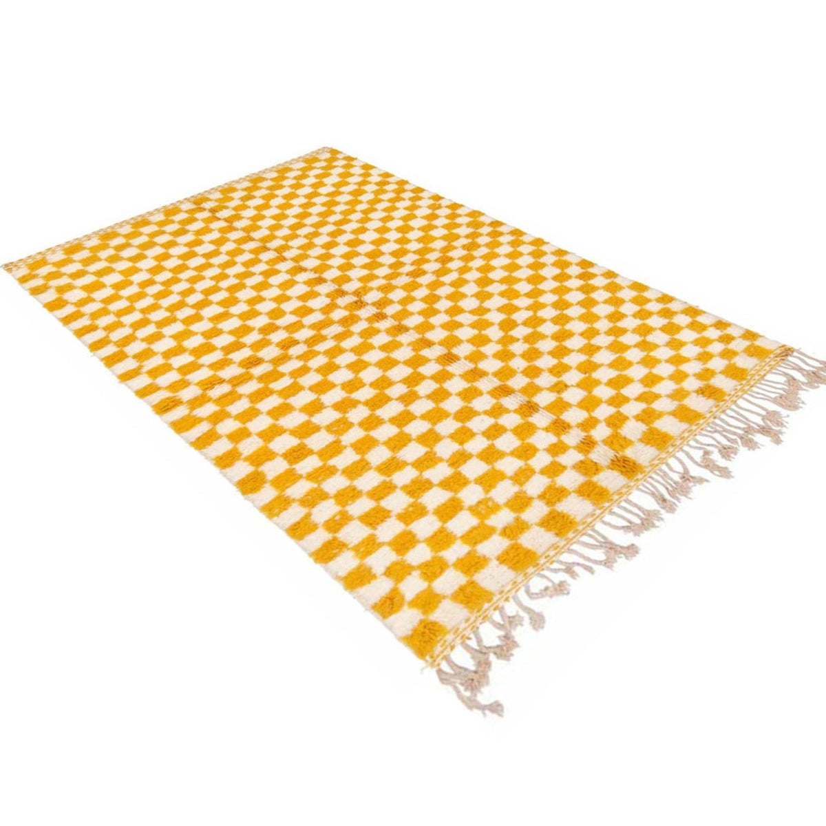Lifestyle shot of the yellow checkered rug with fringe edges in a natural setting.