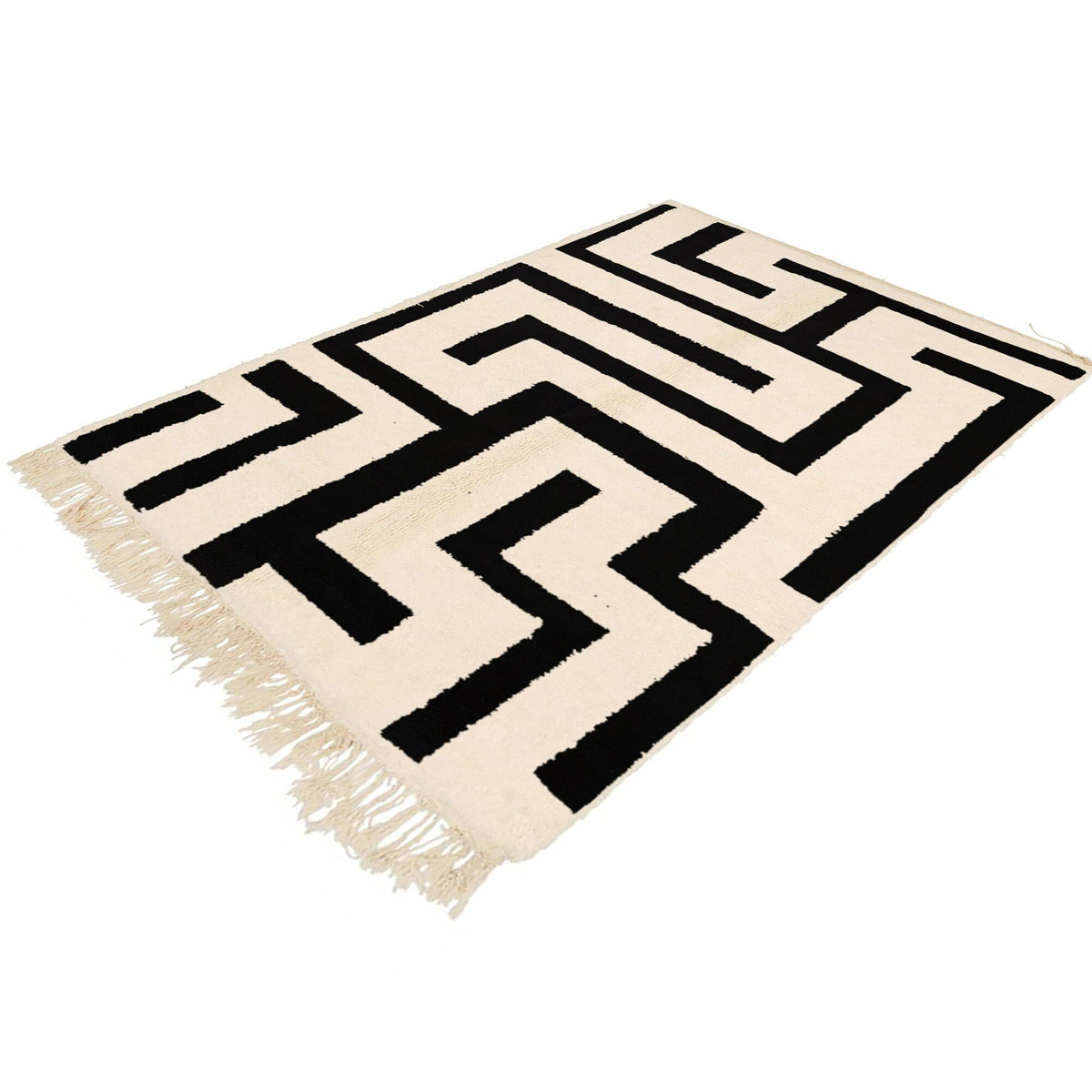 Lifestyle shot of the black and white labyrinth rug showcasing its geometric design in a room setting.