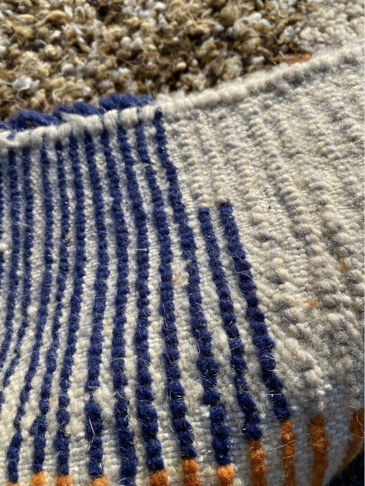 Front view of a multicolor geometric Boujaad Moroccan rug showcasing vibrant blue, orange, cream, and brown colors.