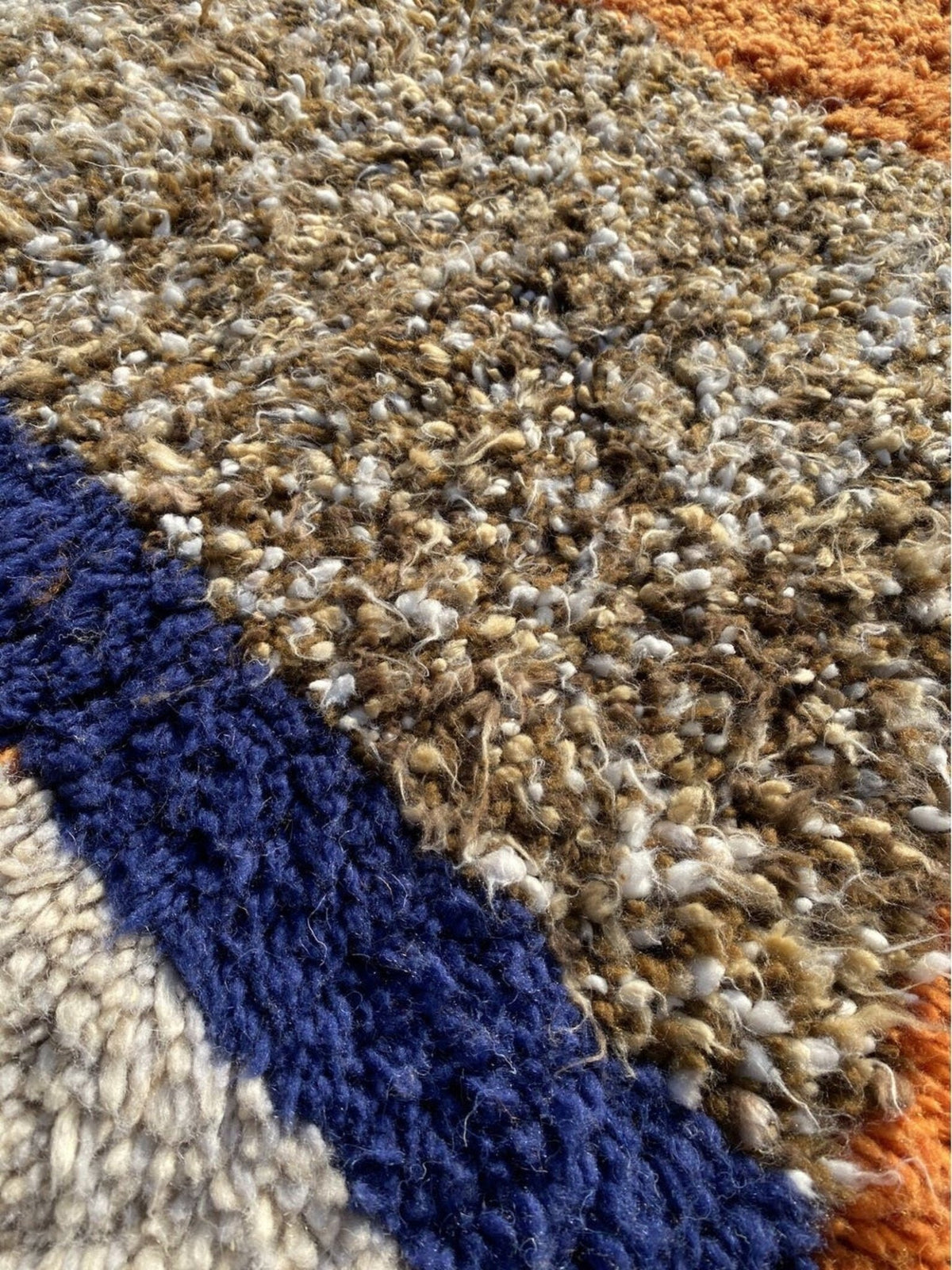 Close-up detail of the textured surface of a multicolor Boujaad Moroccan rug highlighting woven details in cream and black.