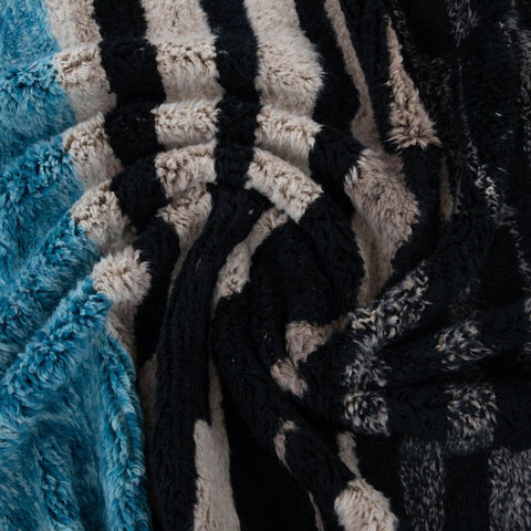Close-up detail of the color contrast on the abstract area rug with a striped pattern.