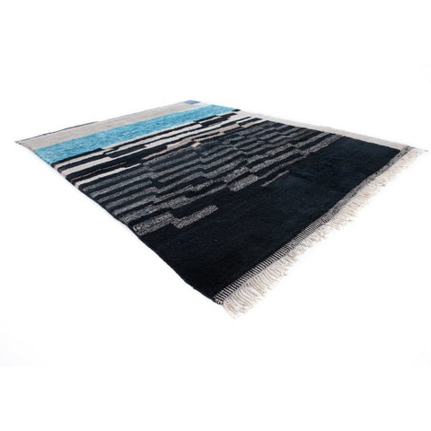 Side view of abstract area rug showcasing layered design in blue and black.