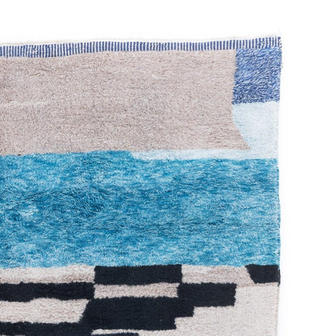 Detail shot of the area rug displaying a striped pattern in blue and black.