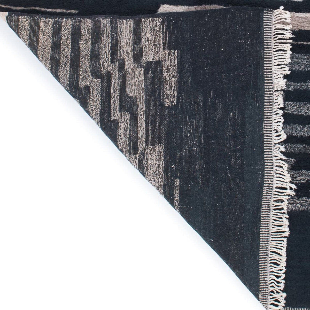 Angled view of the abstract area rug highlighting its textured surface in blue and beige.