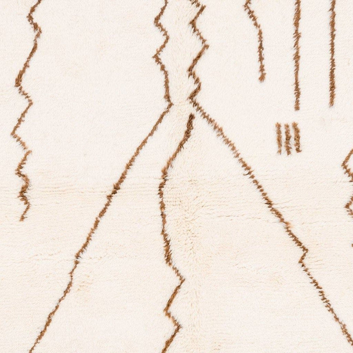 Close-up detail of the off-white area rug displaying line patterns.