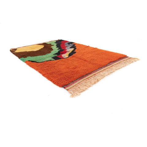 Side view of the orange rug featuring a colorful pattern.
