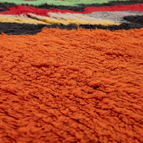 Lifestyle shot of the orange rug with vibrant colors in a room setting.