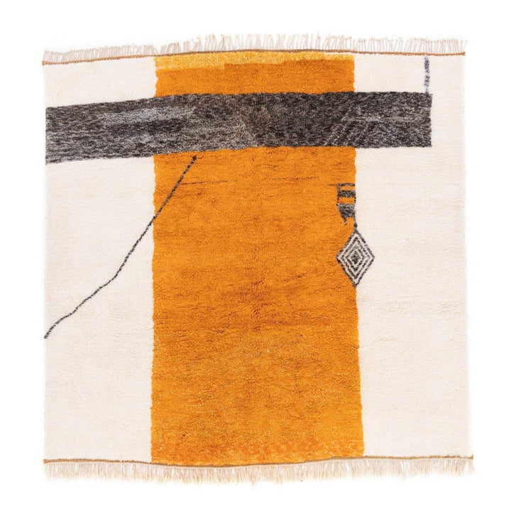 Detail close-up of the orange tribal rug showcasing its pattern and colors.