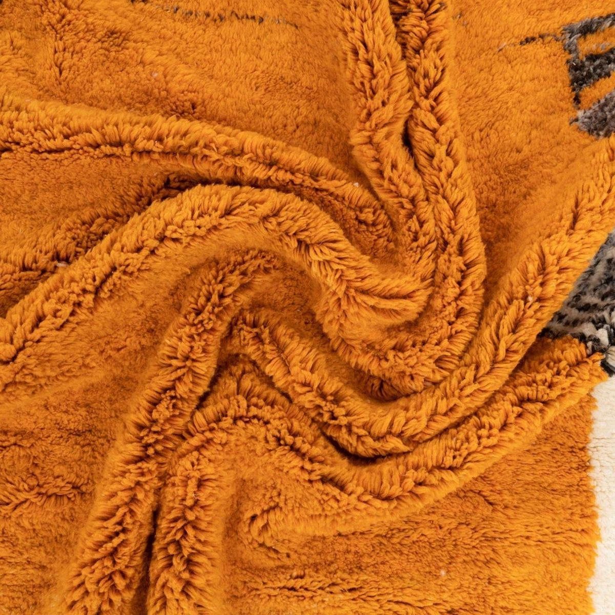 Detail shot of the tribal pattern on the orange tribal rug.