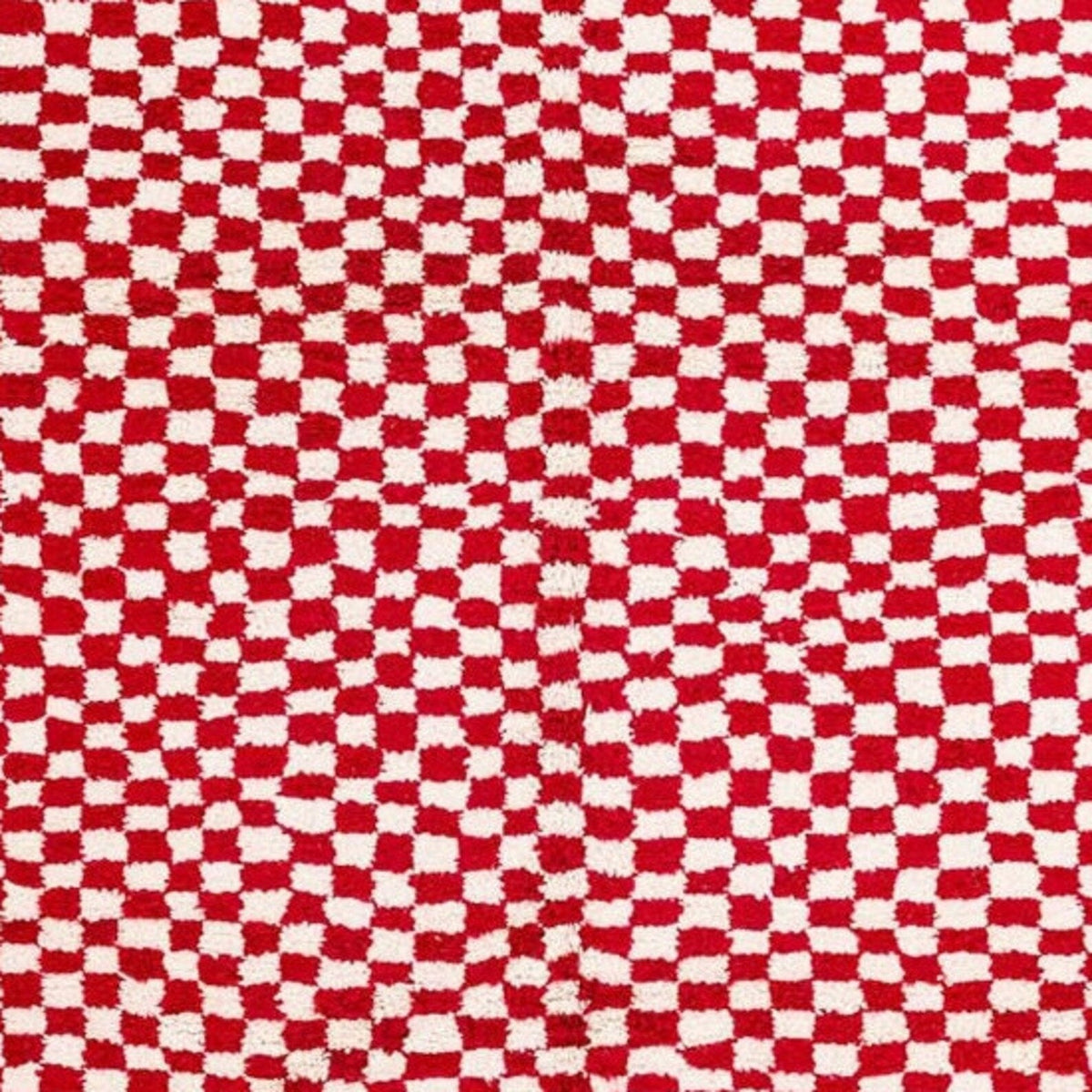 Close-up detail of the pink checkered rug showing its soft texture.