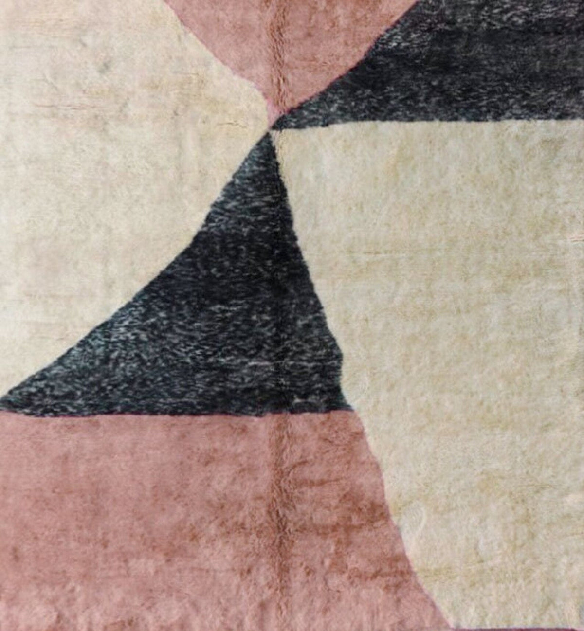 Detail close-up of the pink Moroccan rug showing its geometric pattern and handmade texture.