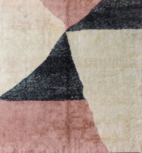 Detail close-up of the pink Moroccan rug showing its geometric pattern and handmade texture.
