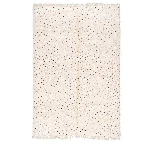Front view of an off-white polka dot rug with a black pattern on a white background.
