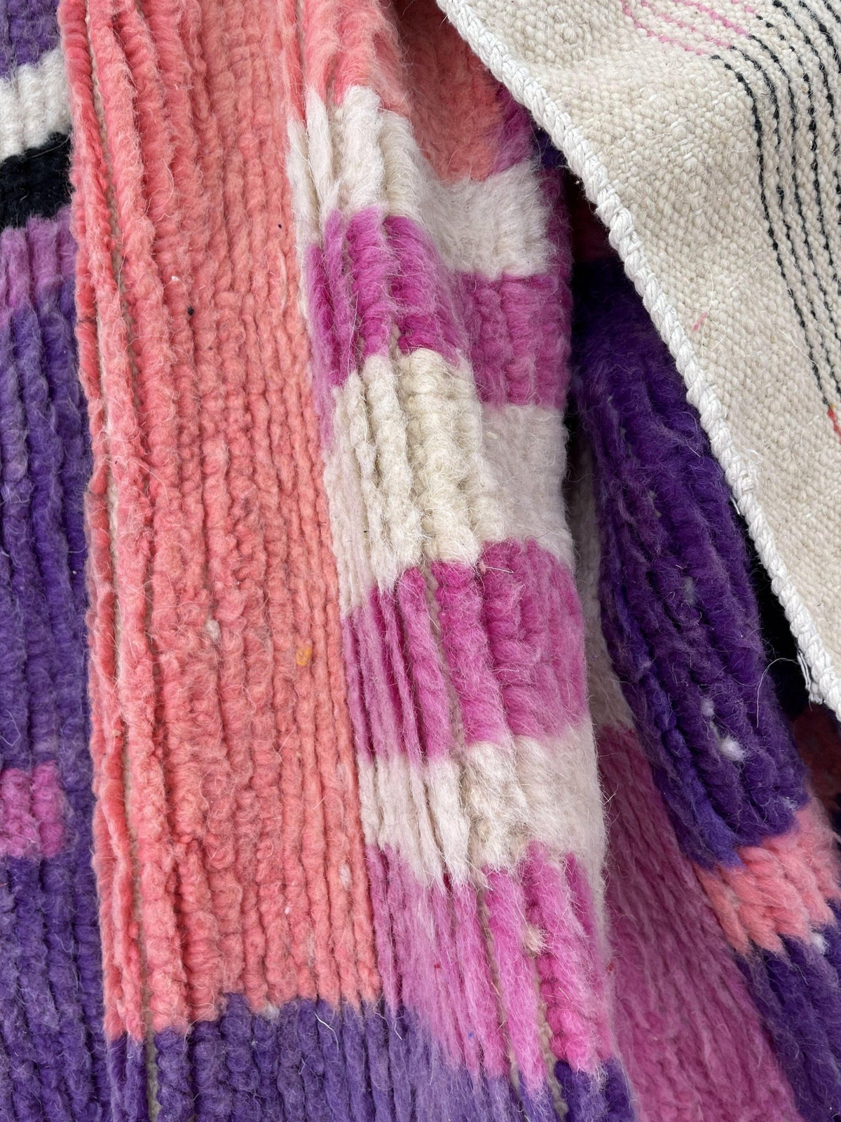 Lifestyle view of a purple and pink patterned Moroccan rug showcasing its vibrant colors.