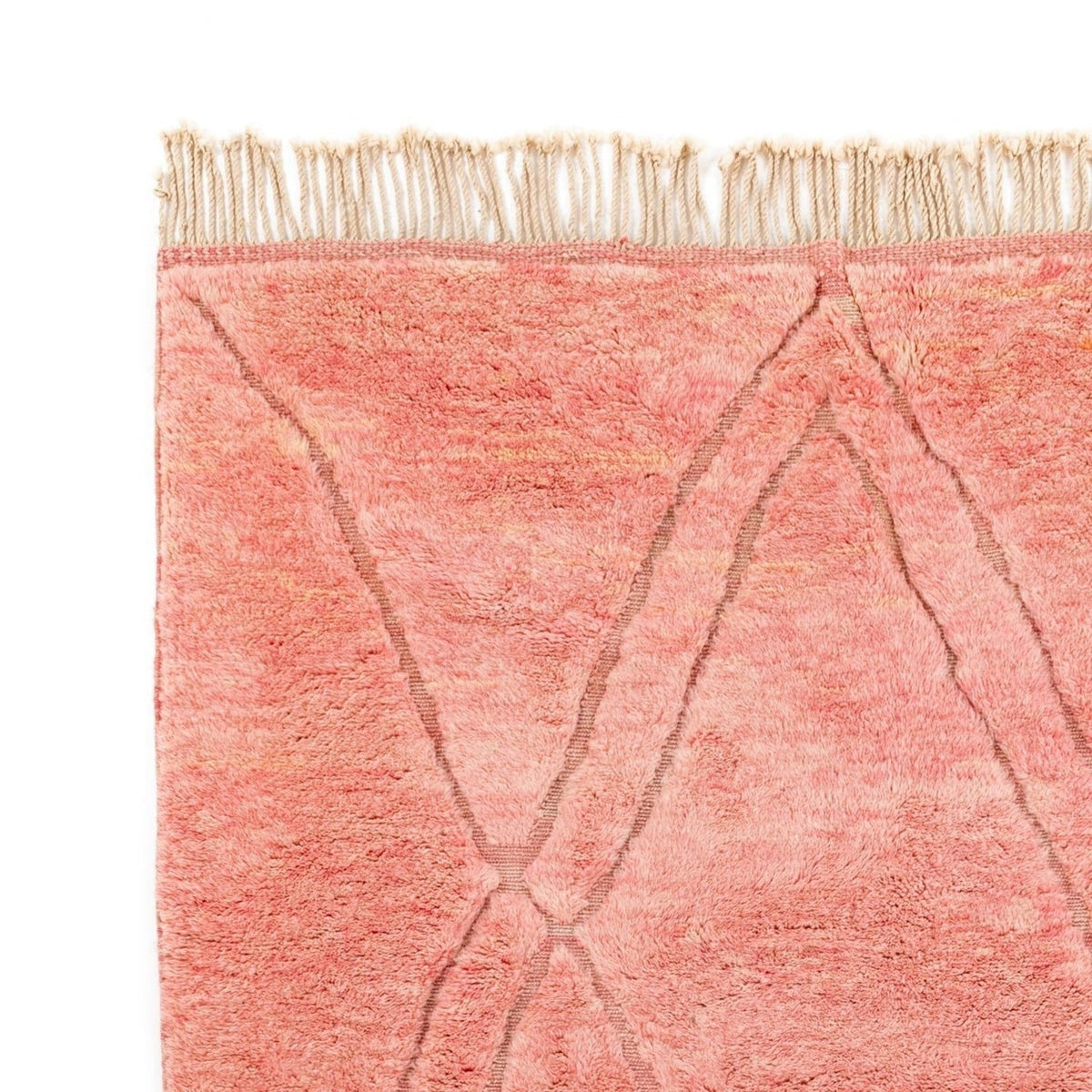 Close-up detail of the rose and yellow rug featuring a geometric pattern and soft texture.