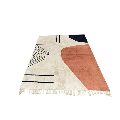 Close-up detail of the coral and cream abstract Moroccan rug highlighting its geometric design.