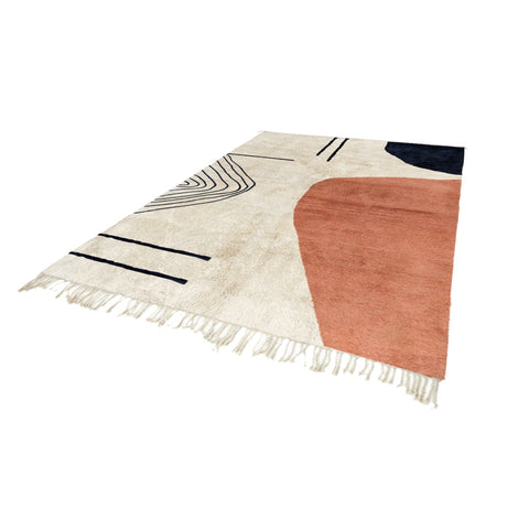 Side view of the coral and cream abstract Moroccan rug displaying its geometric patterns.