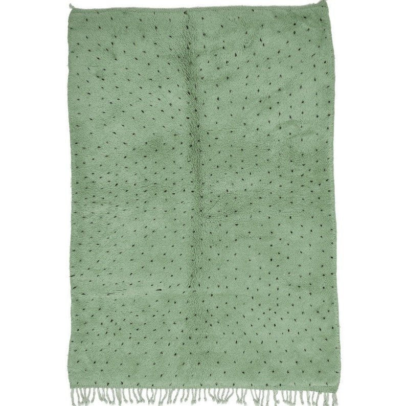 Detail close-up of sage green rug featuring white dots.