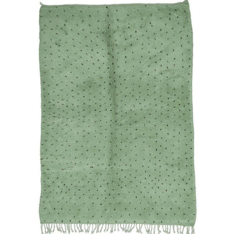 Detail close-up of sage green rug featuring white dots.