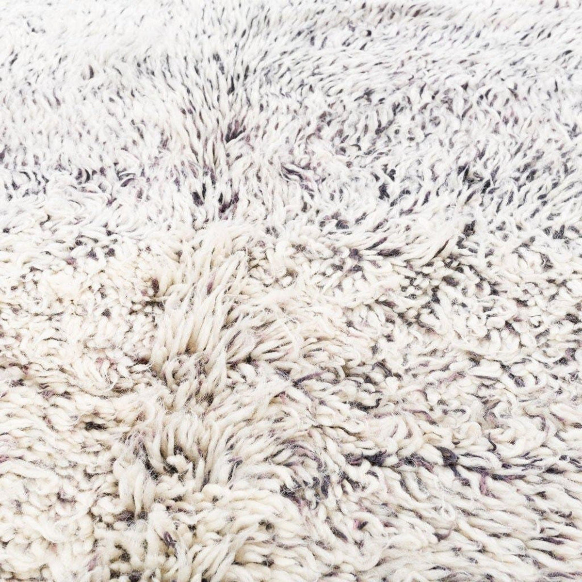 Close-up detail of the abstract design on the diamond patterned rug.