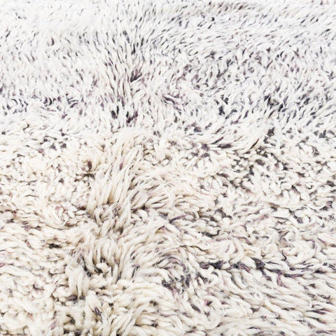 Close-up detail of the abstract design on the diamond patterned rug.