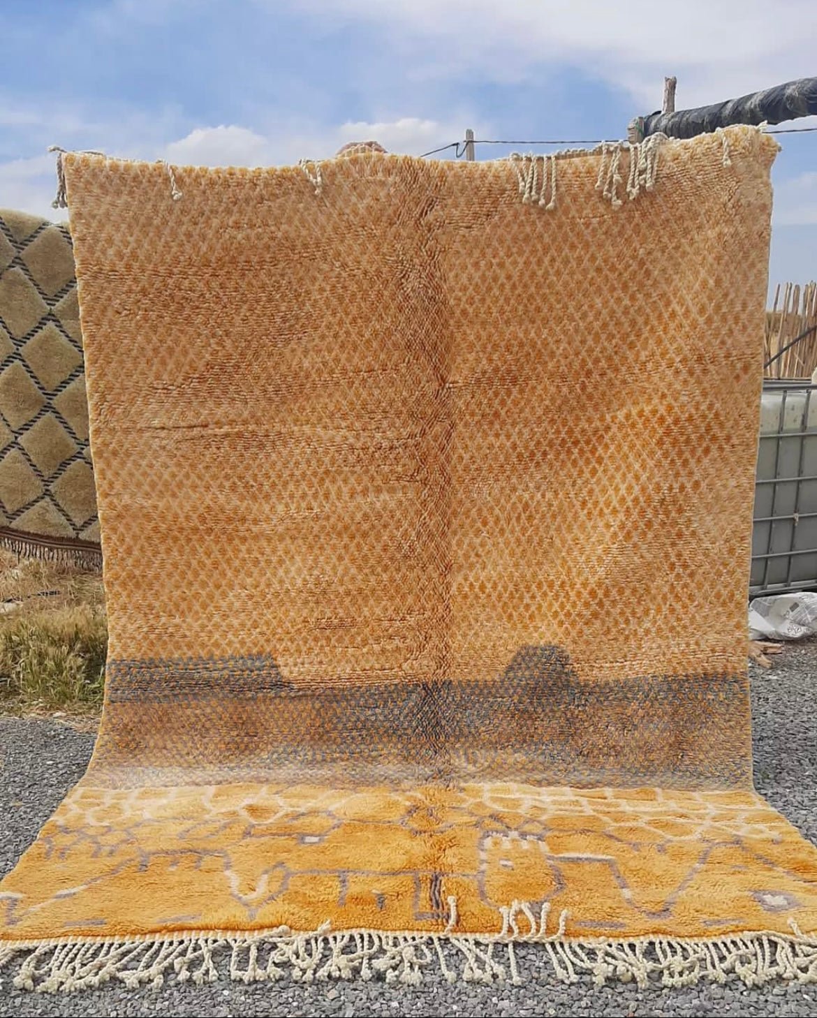 Front view of the orange Moroccan rug featuring geometric patterns and fringe edges.