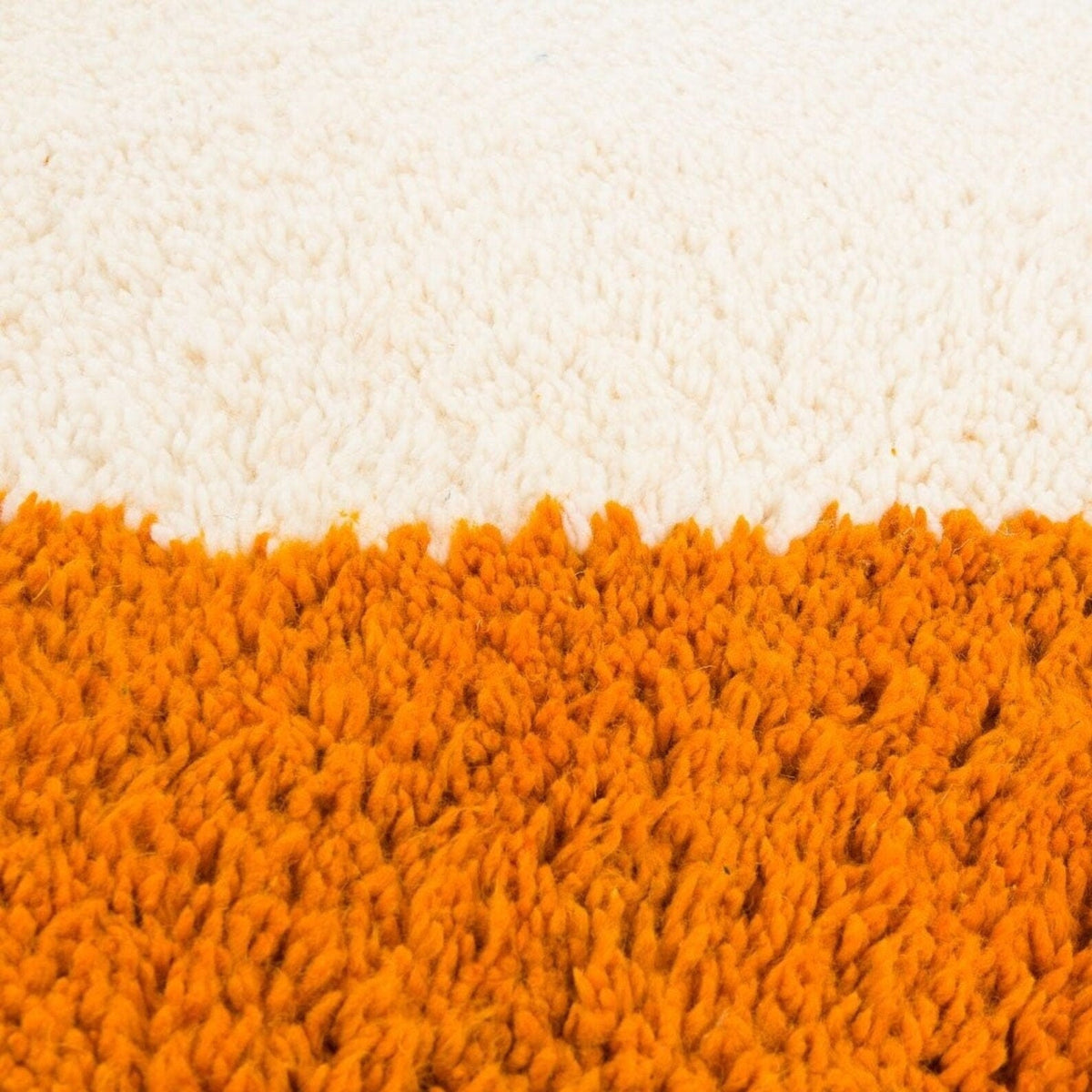 Front view of the orange and beige abstract Moroccan rug showcasing geometric designs.